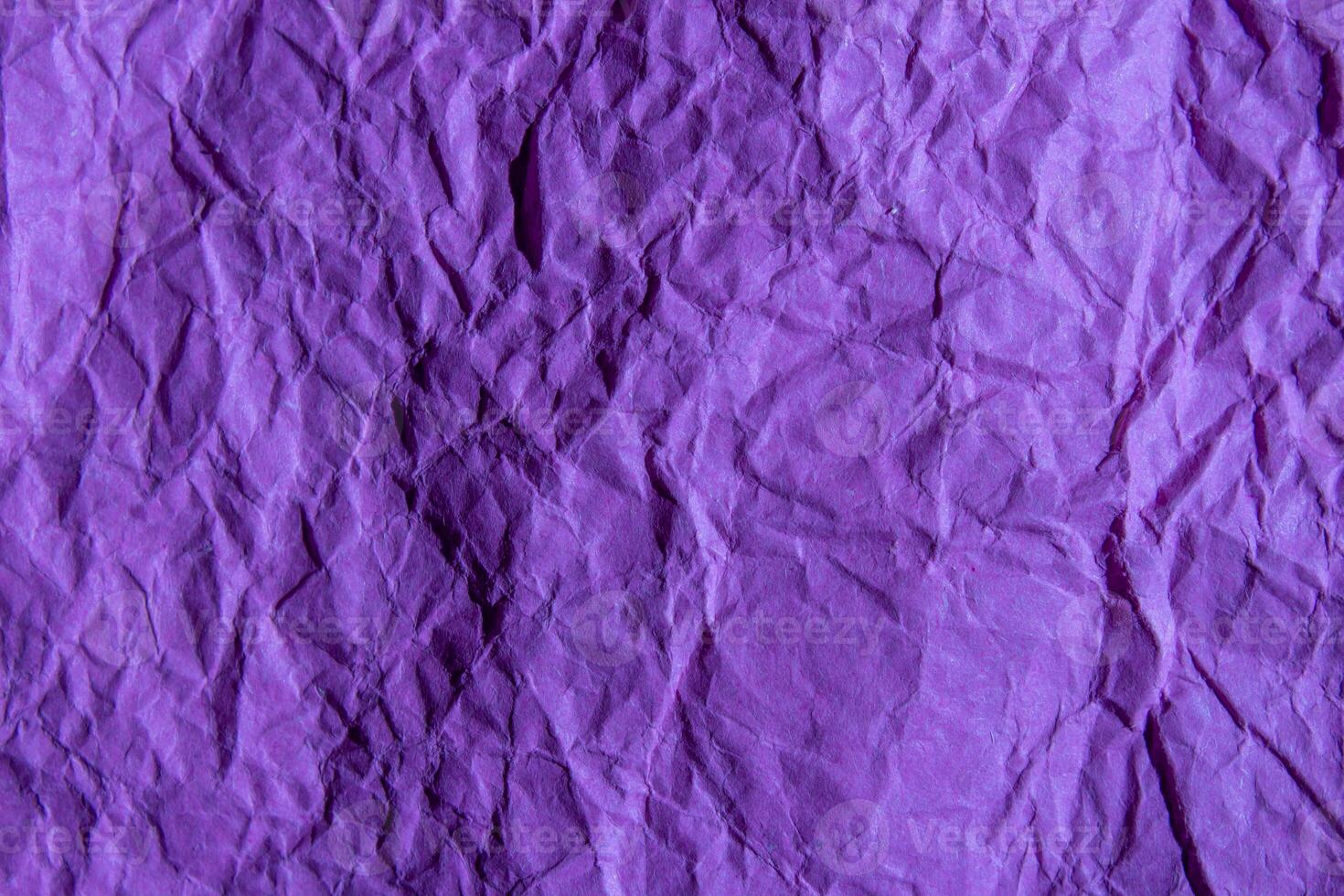 Crumpled purple paper texture background. Wrinkled paper surface for designs. photo