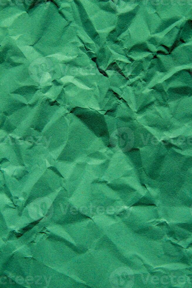 Crumpled green paper texture background photo