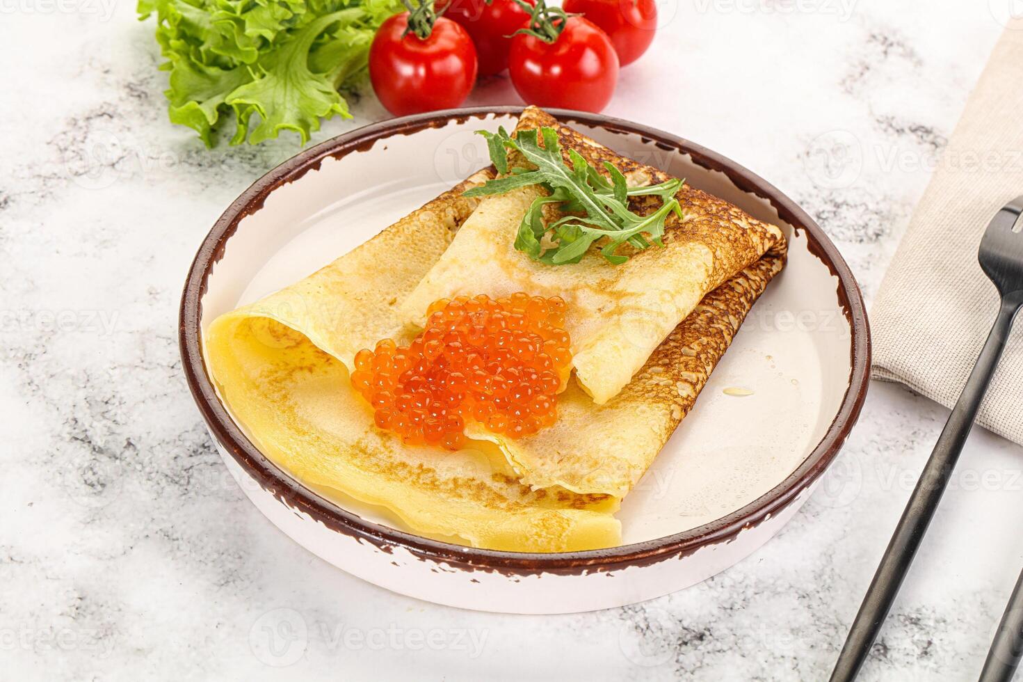 Russian pancake with red caviar photo