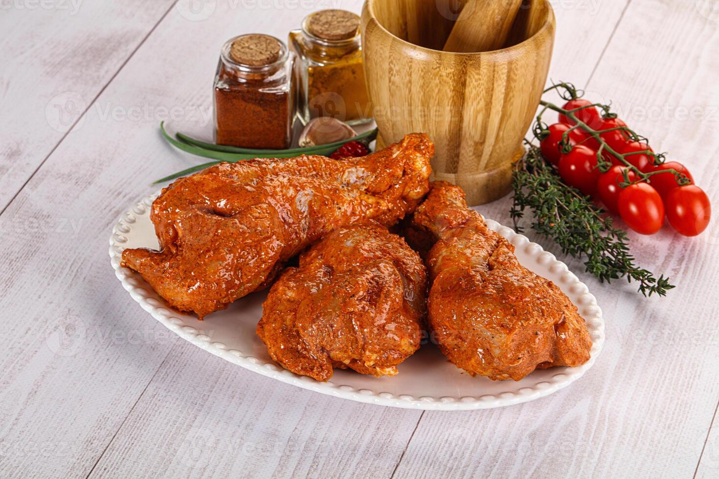 Raw turkey shoulder wing in Indian tandoori marinade photo