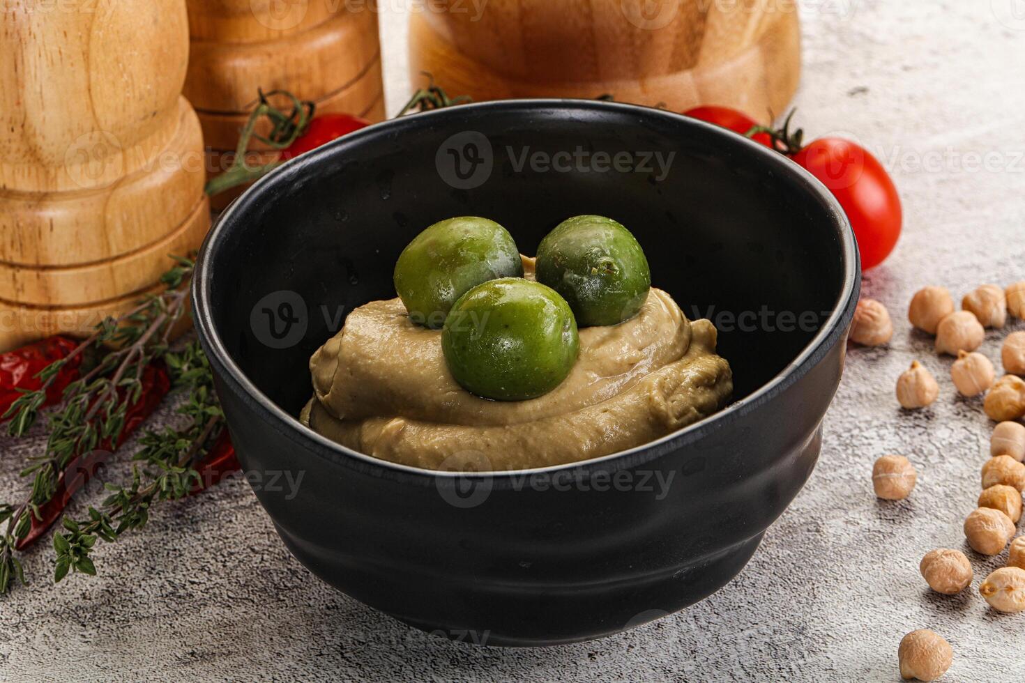 Tasty hummus with green olives photo