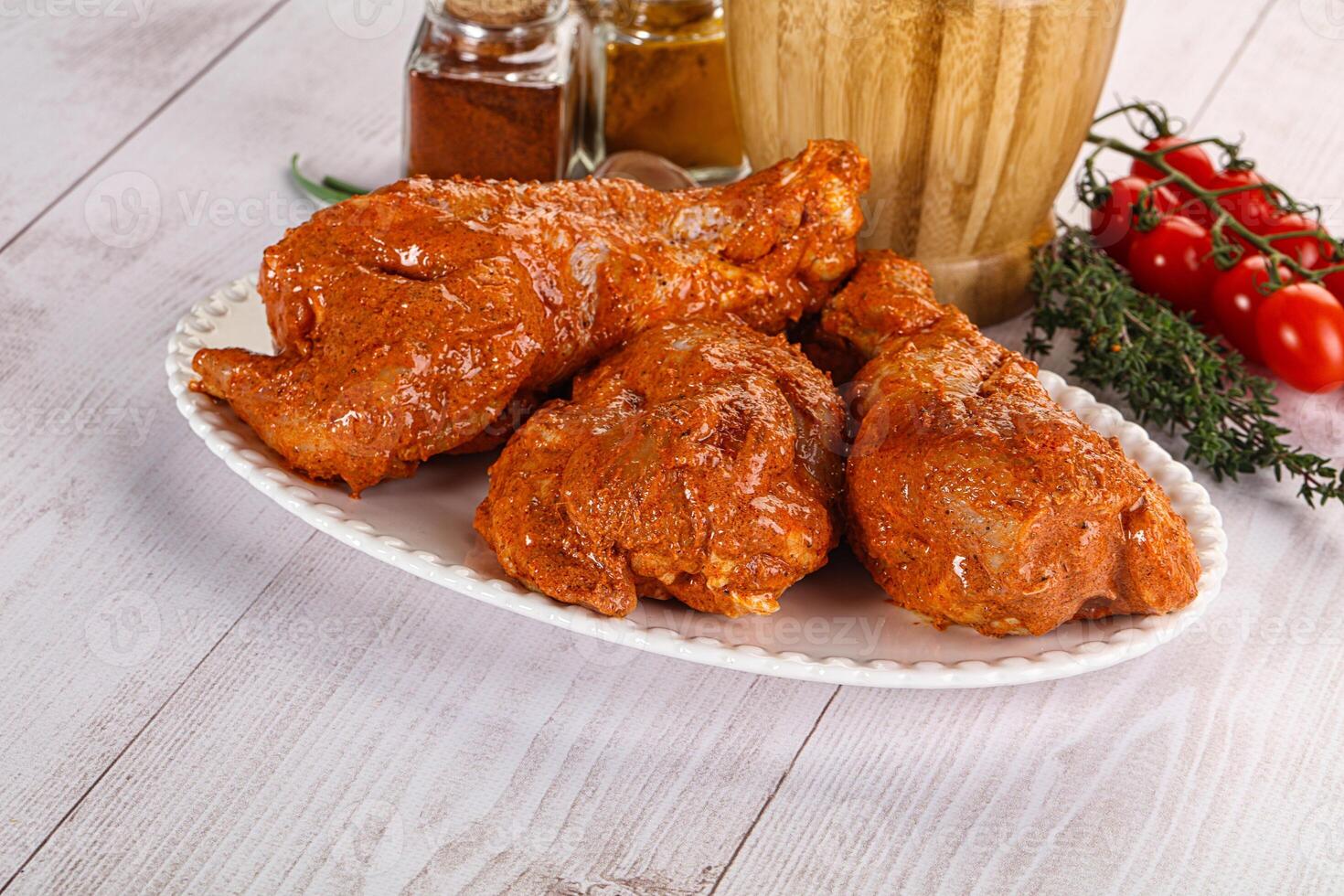 Raw turkey shoulder wing in Indian tandoori marinade photo