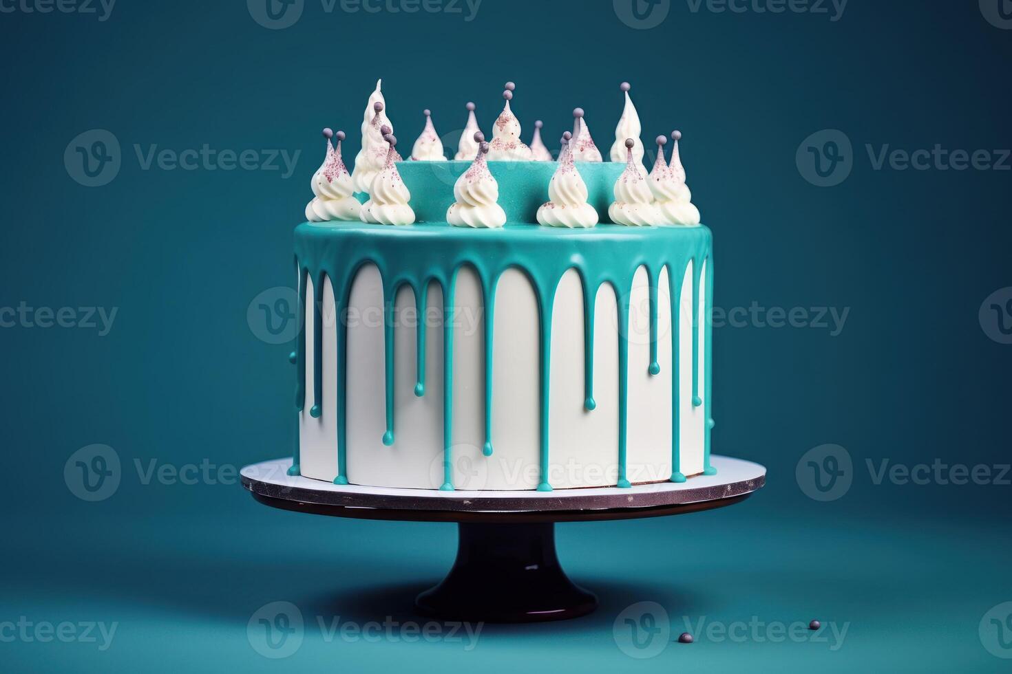 White birthday cake with teal ganache on dark blue background. photo