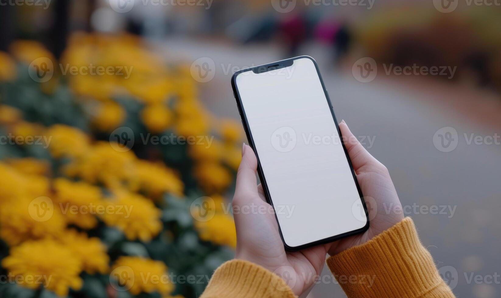 AI generated Female hands holding a smartphone with a white screen on the background of yellow flowers photo