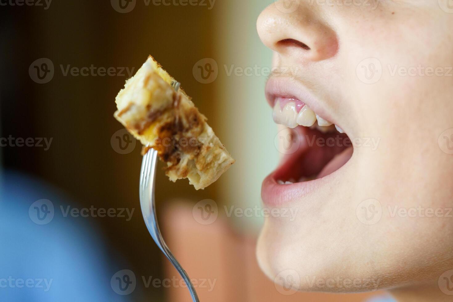 Crop unrecognizable girl about to eat yummy potato omelette photo