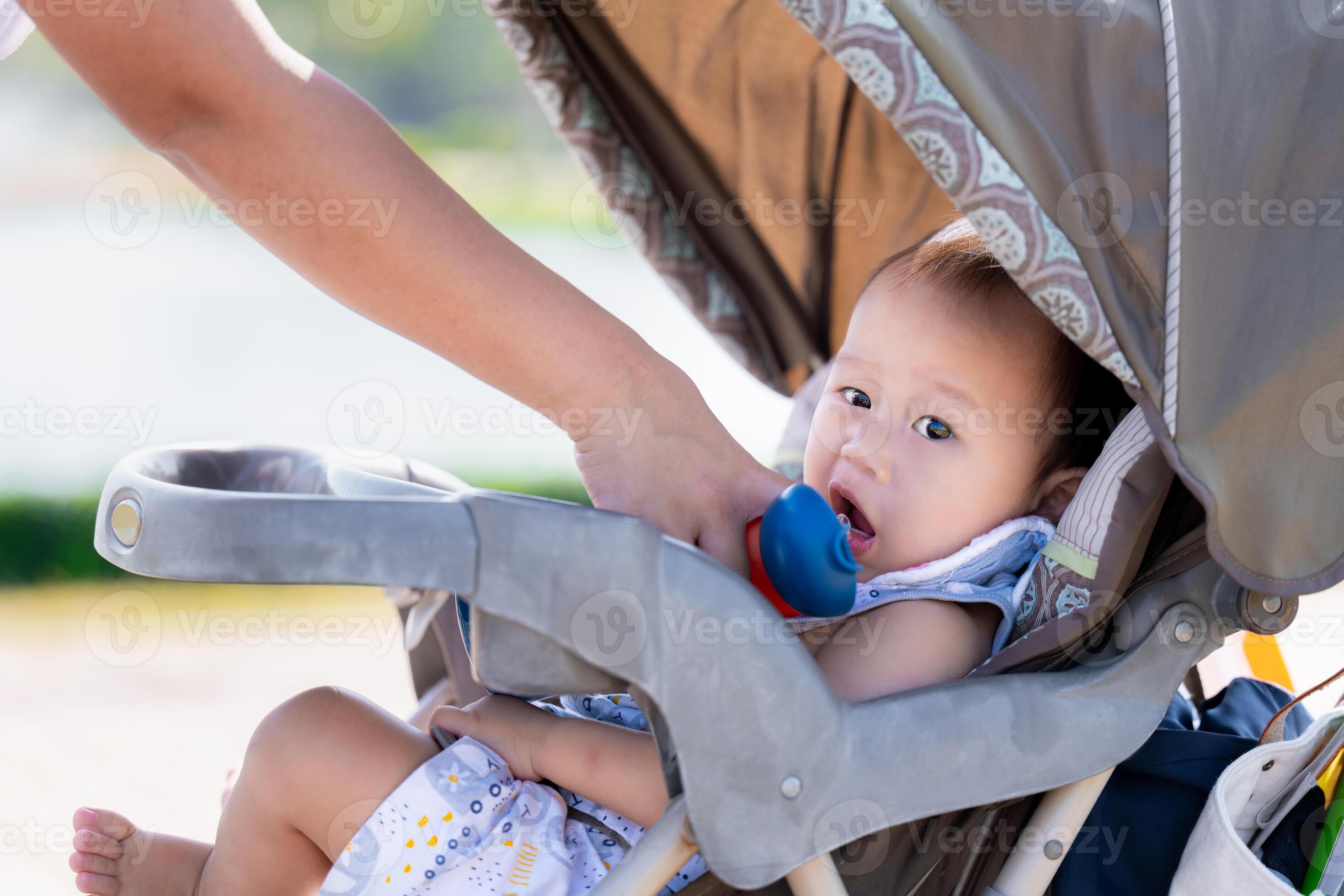 Asian Baby Boy Hydrating with a Straw from Blue Bottle, staying