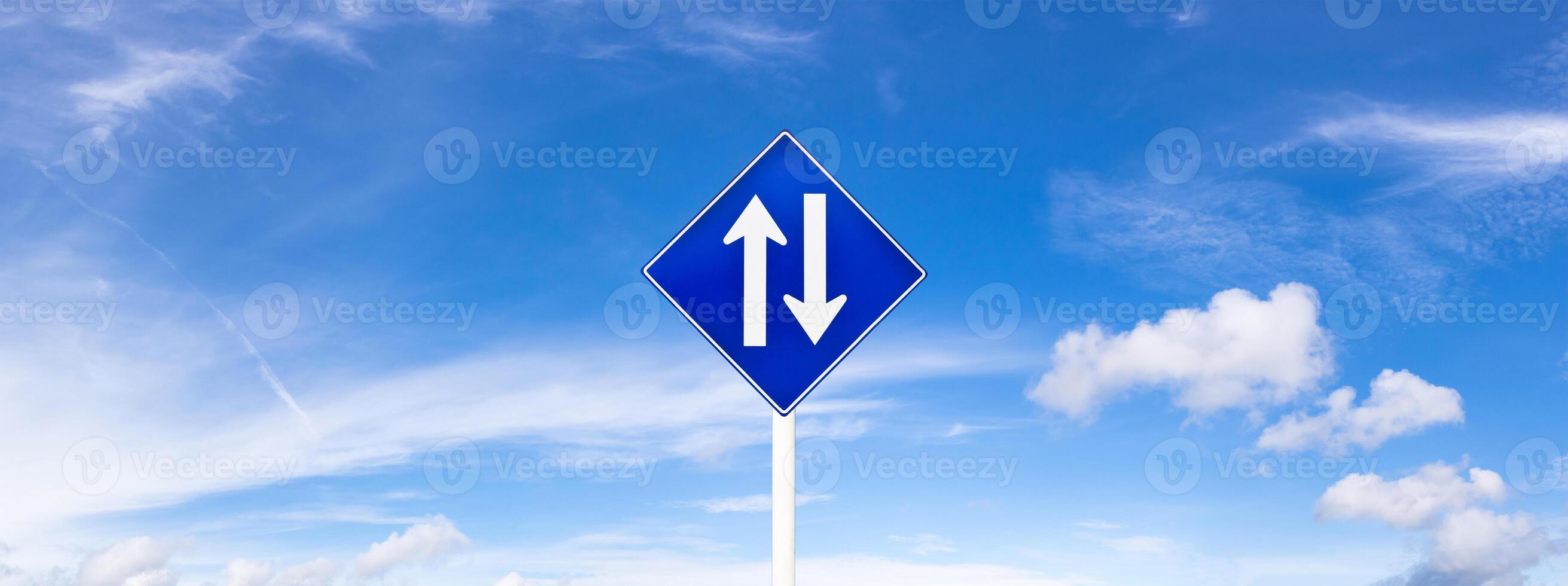 Panoramic blue sky fluffy clouds and road sign photo