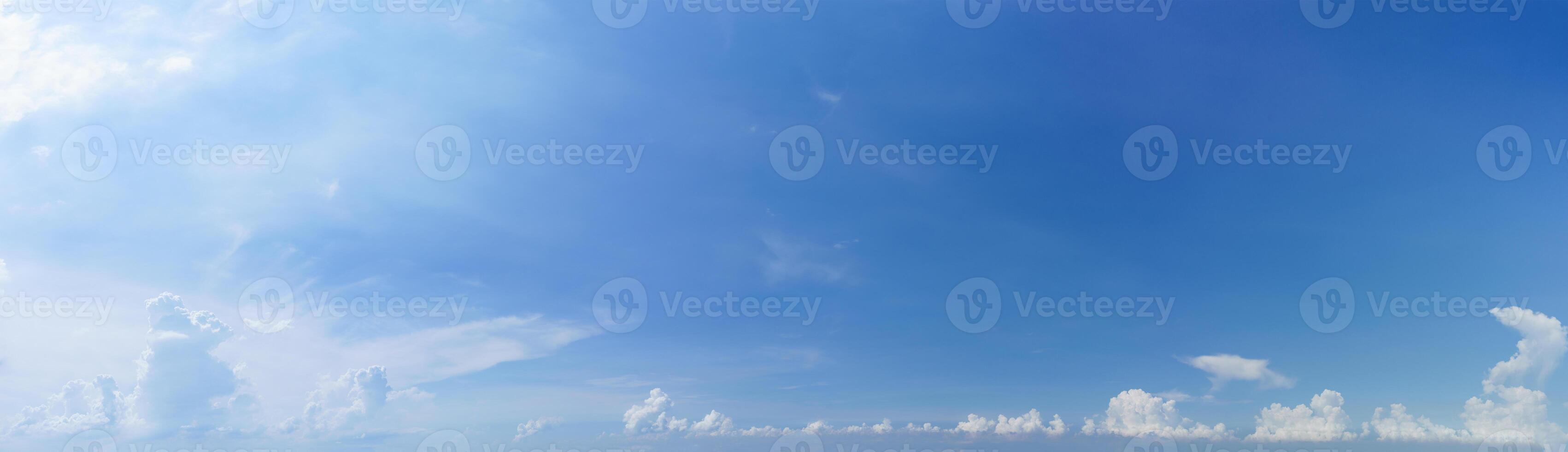 Blue sky with white fluffy clouds photo