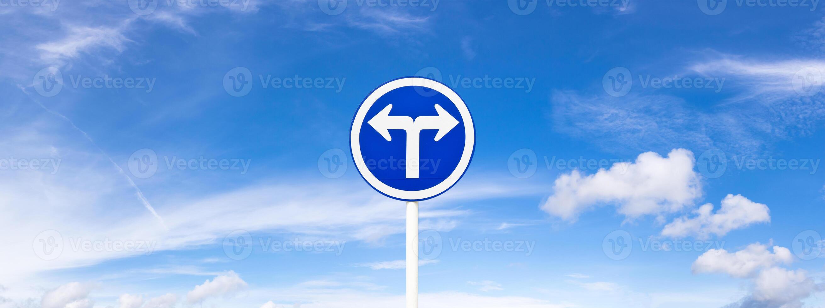 Panoramic blue sky fluffy clouds and road sign photo