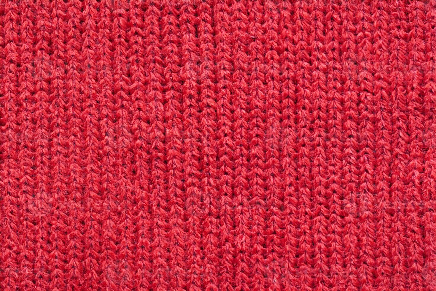 Red knitted wool fabric texture background photo