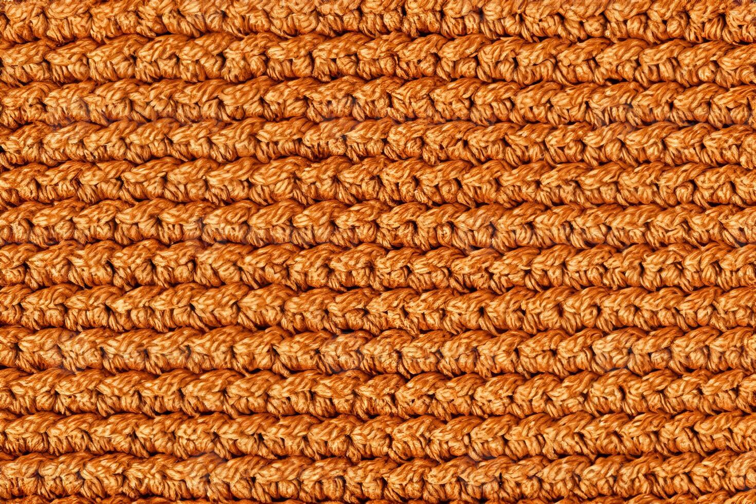 Orange knitted fabric texture background. Top view. Copy, empty space for text photo