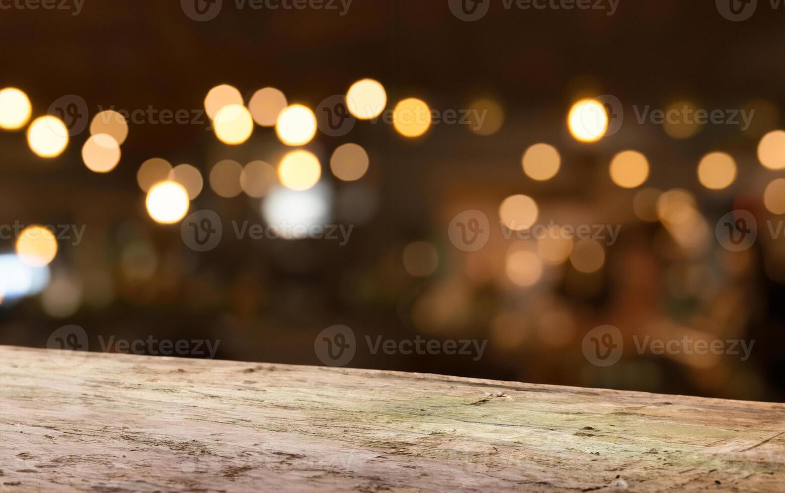 Empty wood table top on blur light gold bokeh of cafe restaurant in dark background photo