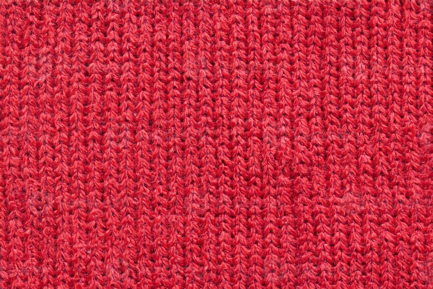 Red knitted wool fabric texture background photo