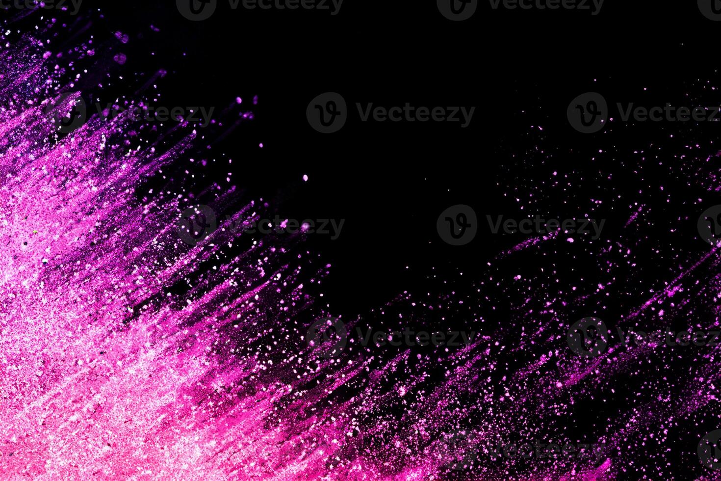 Abstract colorful powder explosion on black background.Freeze motion of dust splash.Painted Holi. photo