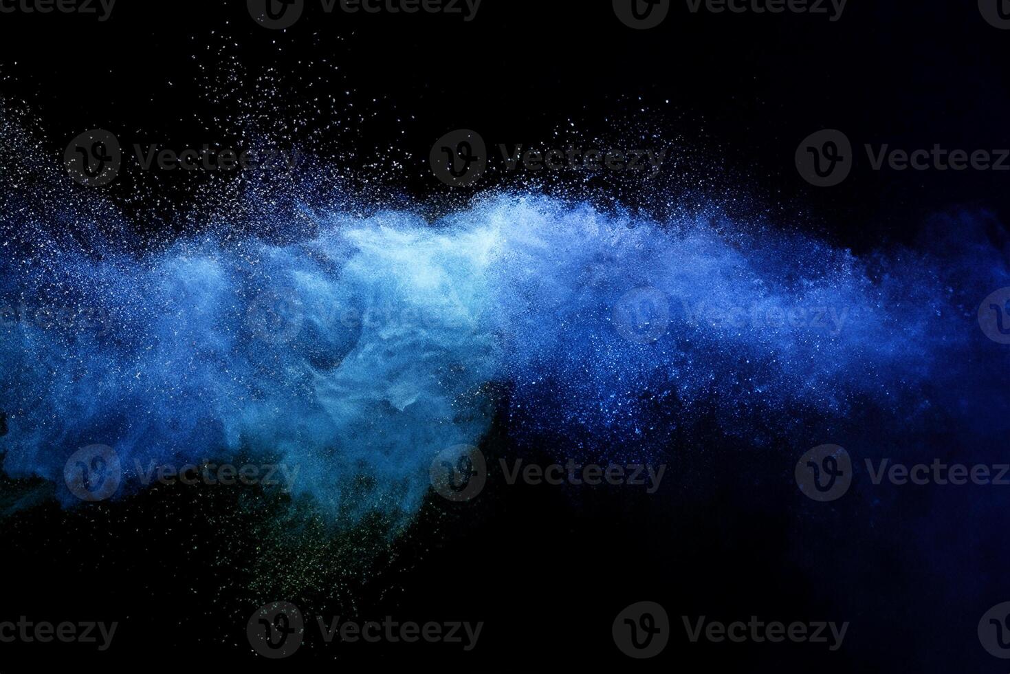 Abstract brown powder explosion. Closeup of blue dust particle splash isolated on black background. photo