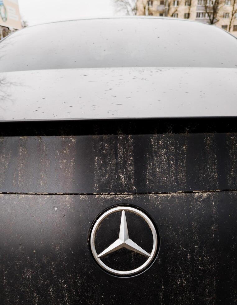 Minsk, Belarus, February 29, 2024 - dirty logo Mercedes of dark car photo