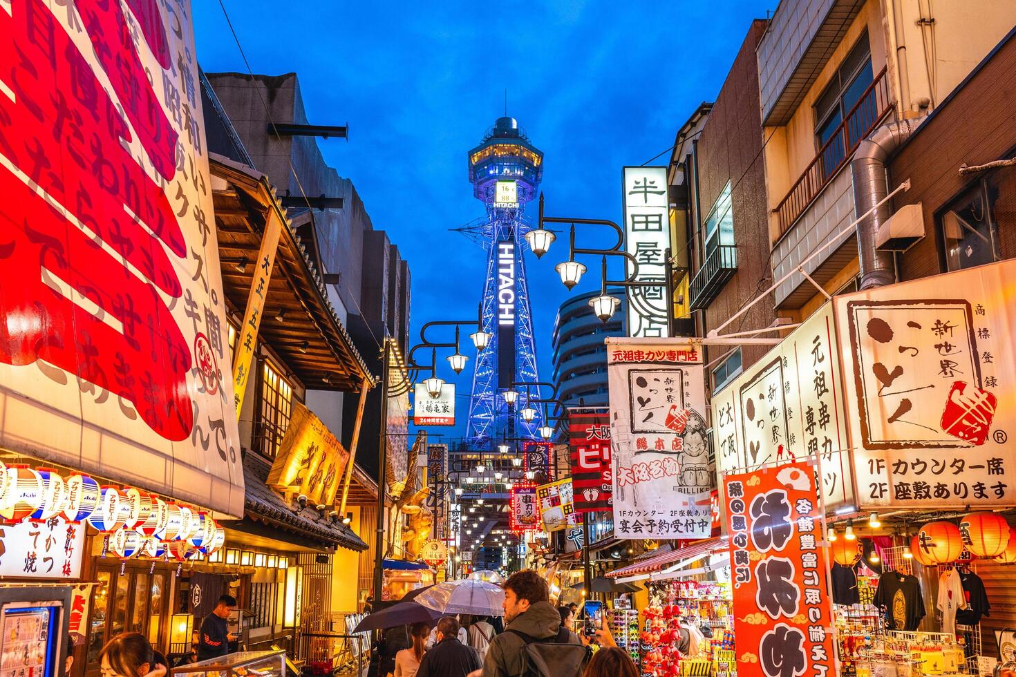 Street view of Shinsekai and Tsutenkaku tower in Osaka, Japan. Shinsekai, lit. New World, is a retro area developed before the war and then neglected in the decades afterwards. photo