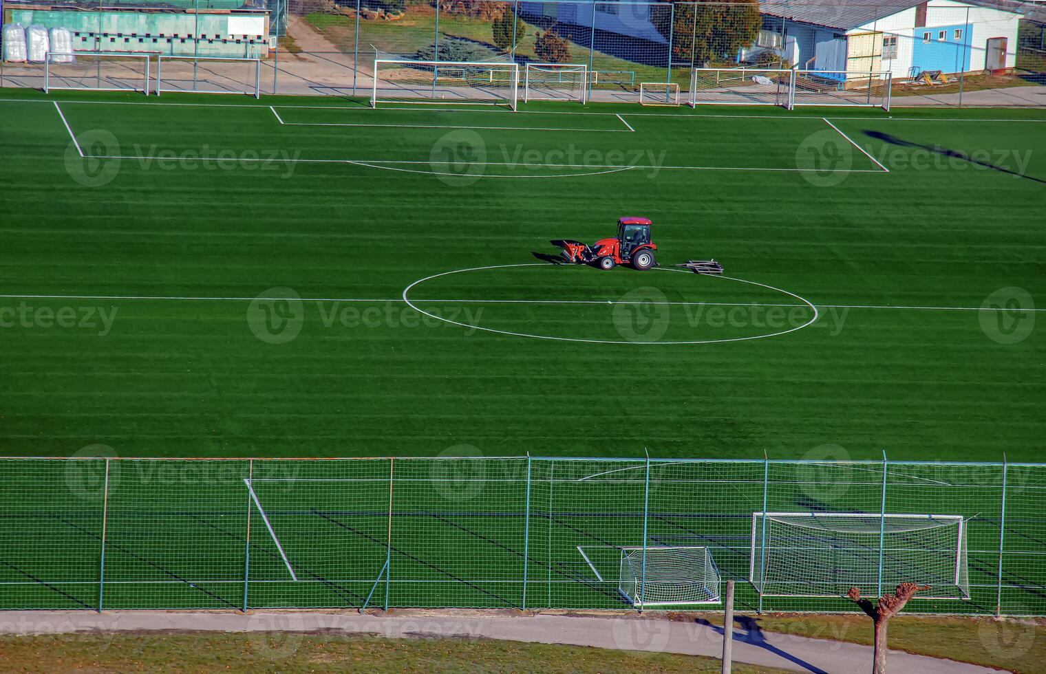 Top view on a tractor cares for the football field photo