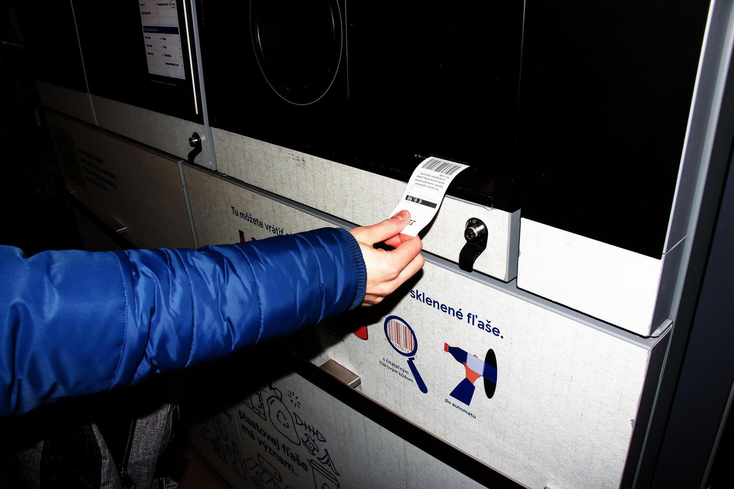 Nitra, Slovakia - 01.16.2024 Close-up of a man's hand receiving a check for returned containers. photo