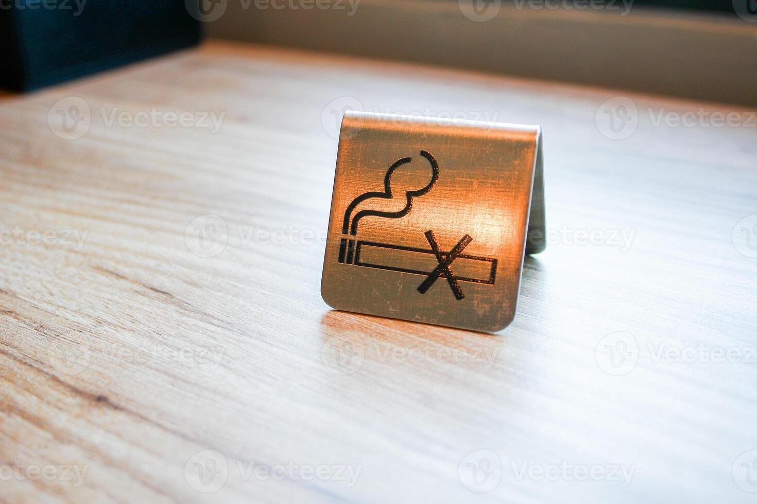 Smoking sign on a wooden table, with copy space for text photo