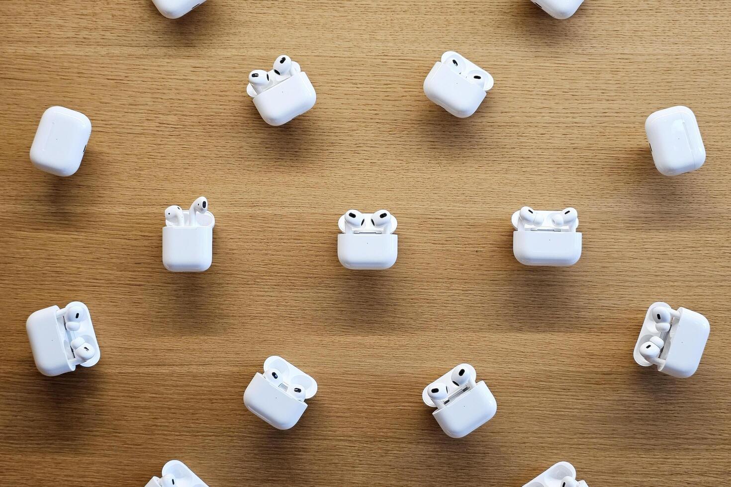 BANGKOK, THAILAND SEPTEMBER 23, 2023 AirPods dispalying on wooden wall. are wireless Bluetooth earbuds designed by Apple Inc.. photo