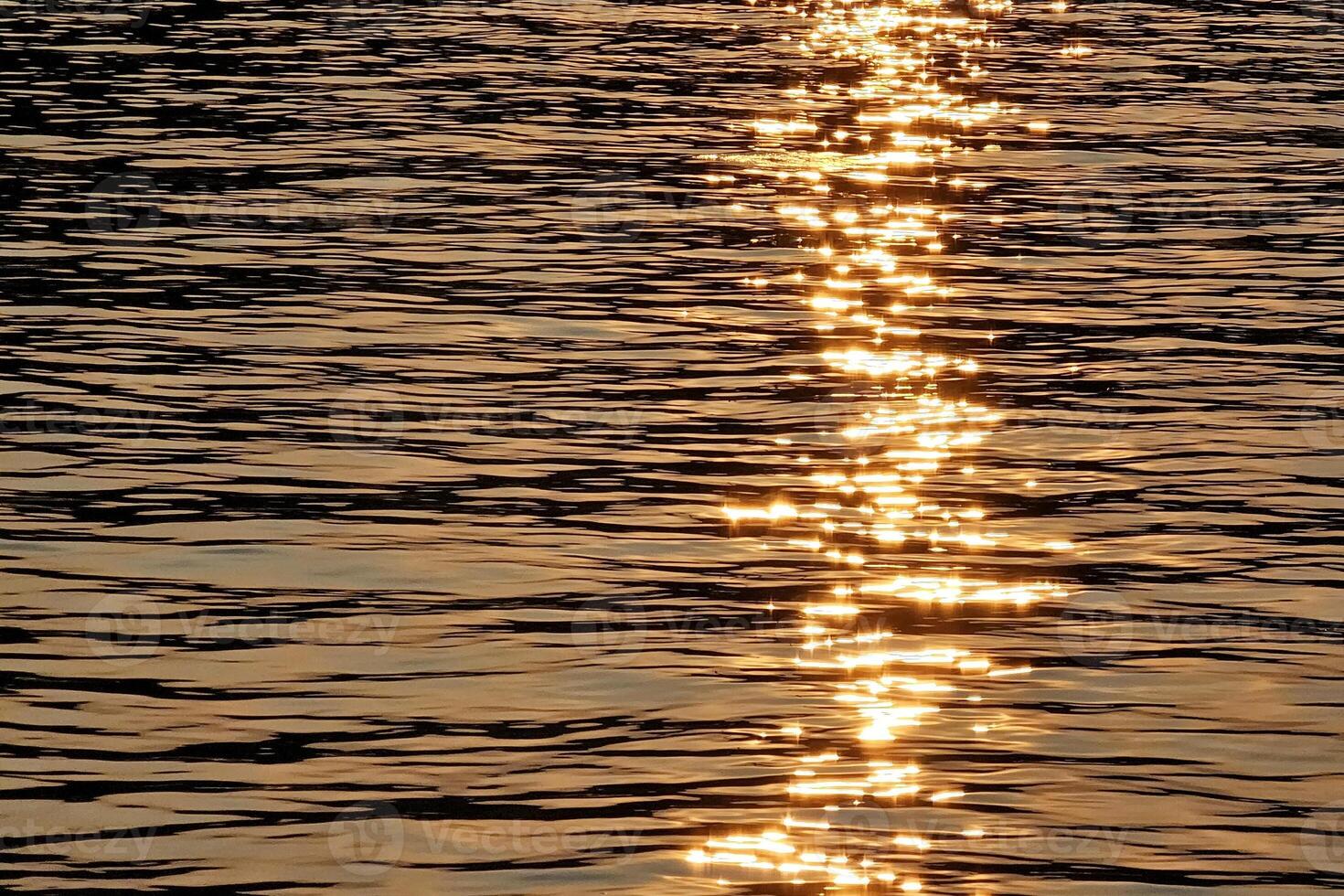 Golden Sunset Light on the Surface of the River for Background. photo