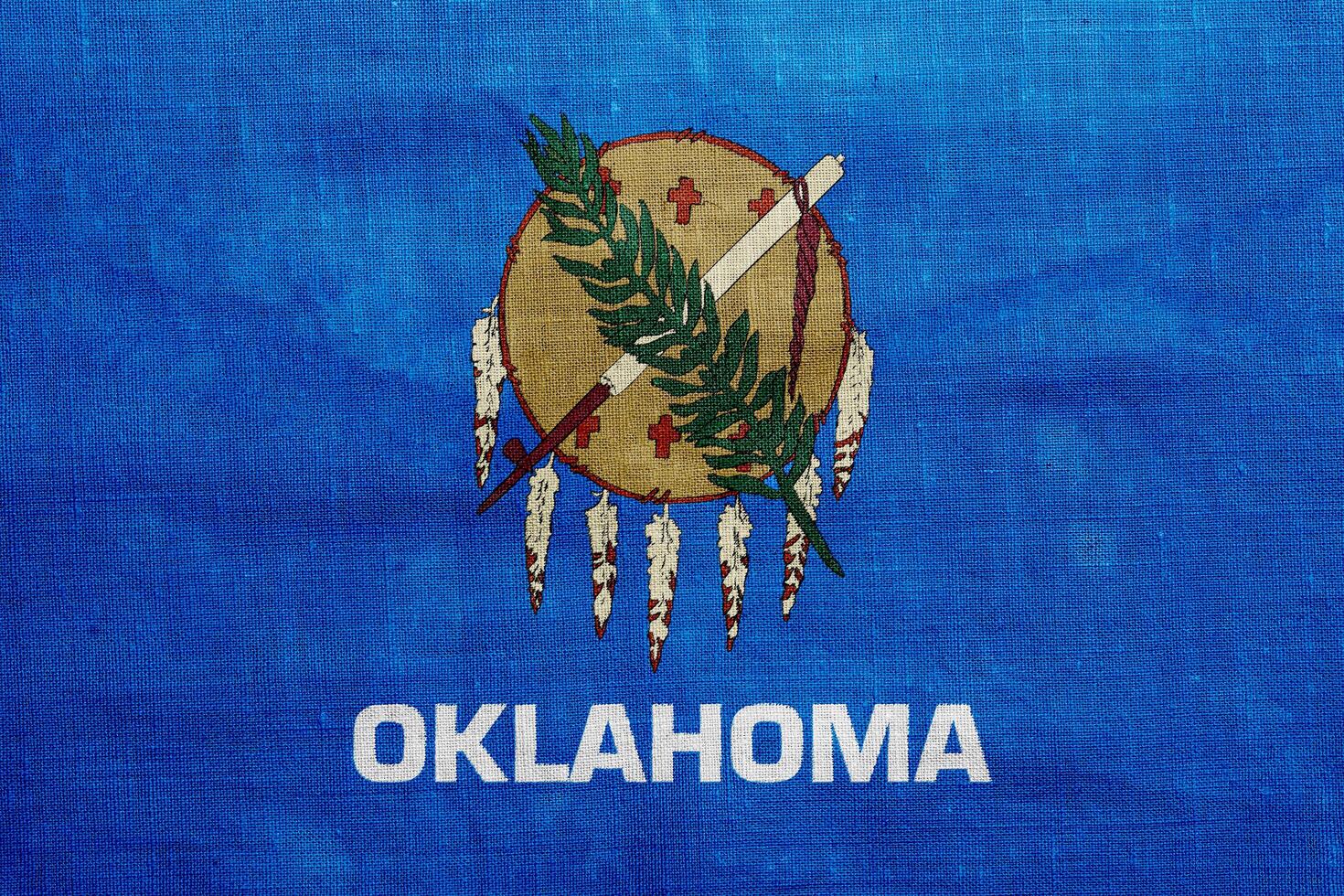 Flag of Oklahoma state USA on a textured background. Concept collage. photo