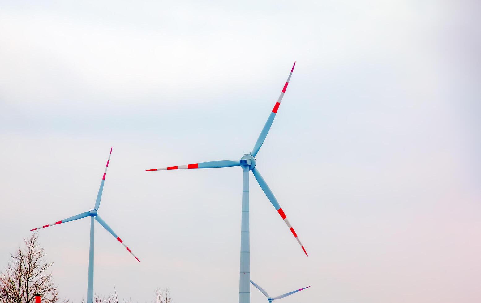 Wind turbine station windmill park next to the road in Austria in cloudy weather. photo