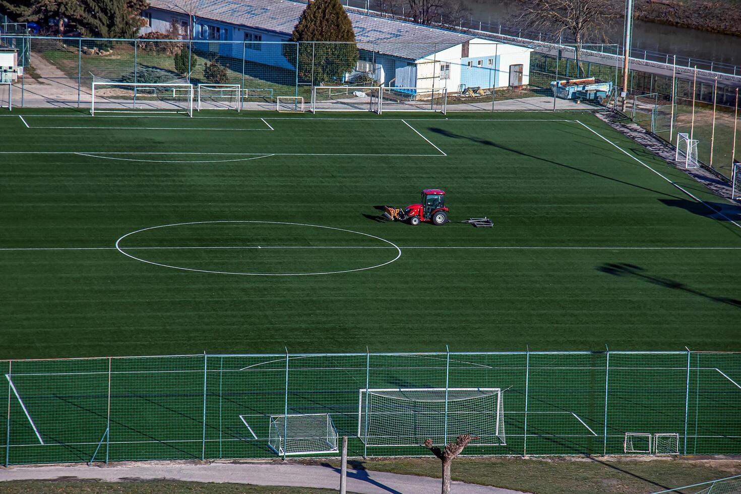 Top view on a tractor cares for the football field photo