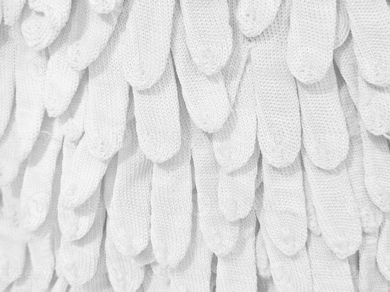 Cotton Knitted Gloves Wall Background. photo