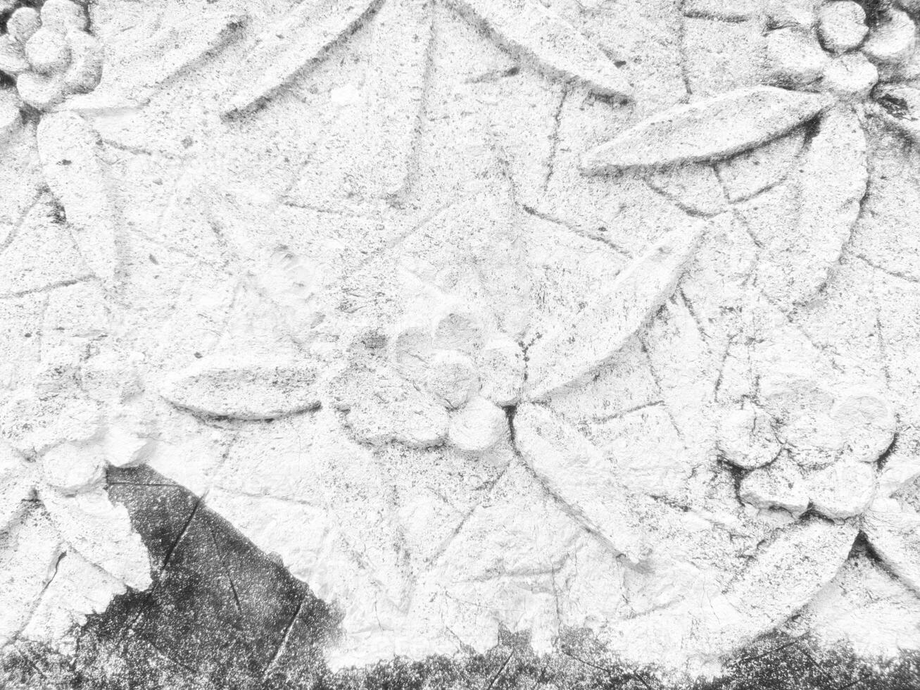 White Ancient Vintage Thai Sculpture on Stone Wall. photo