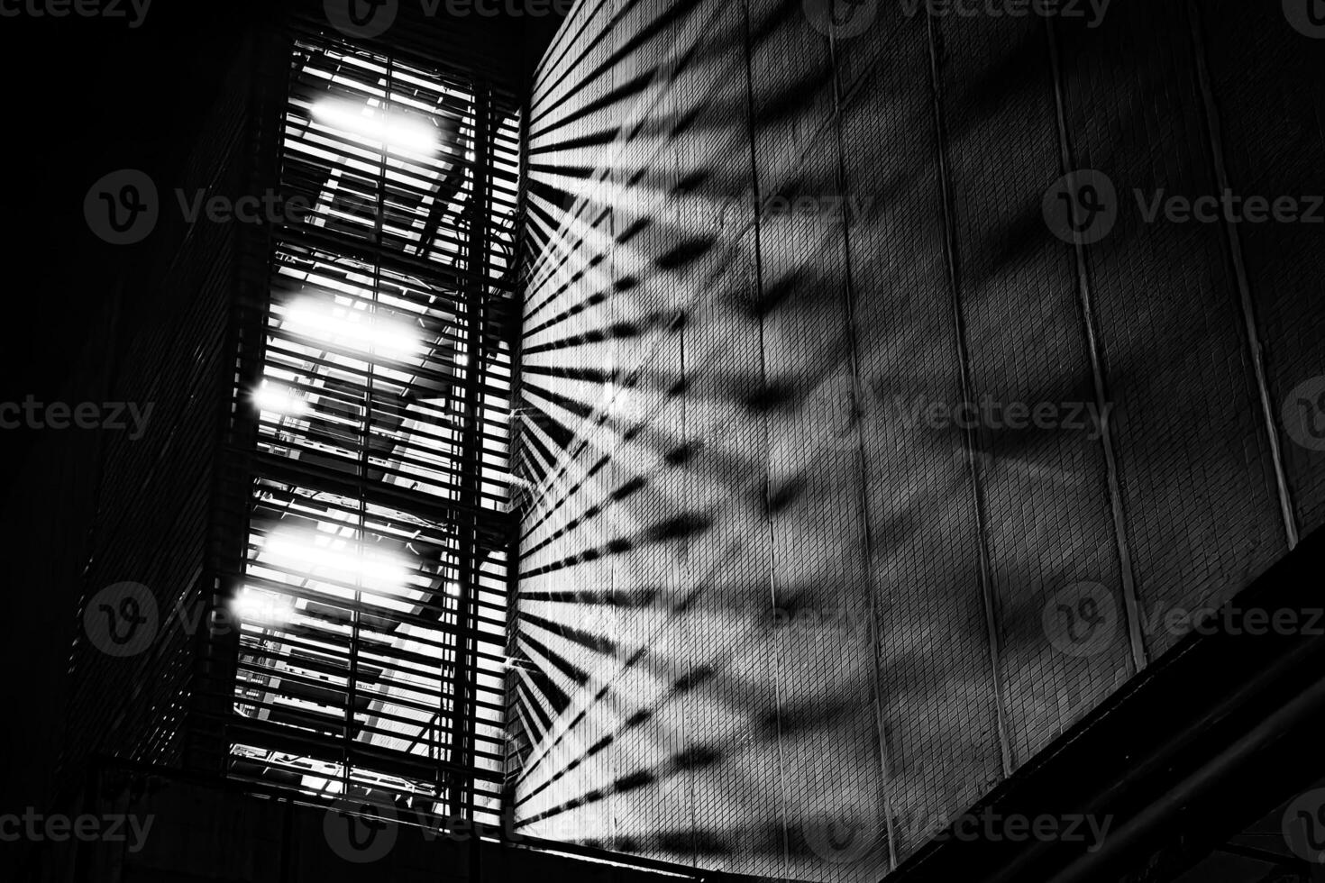 Fire Escape Stair with Light Beam at Night. photo