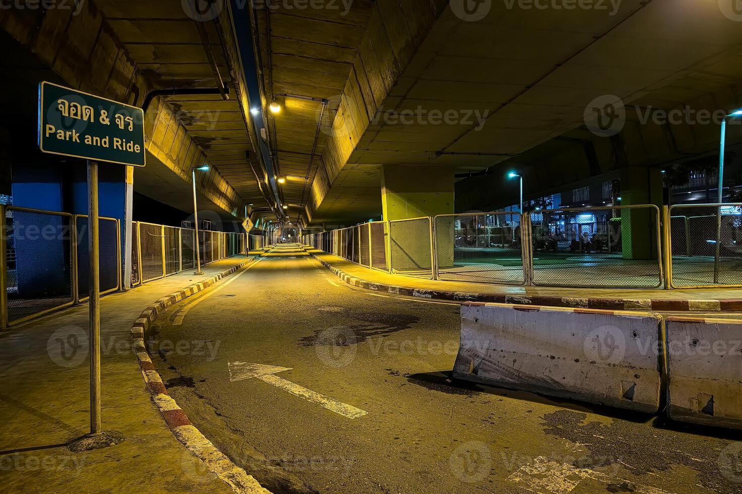 Scenery of Under Overpass Bridge at Night. Translation Thai Text on Sign is Park and Ride. photo