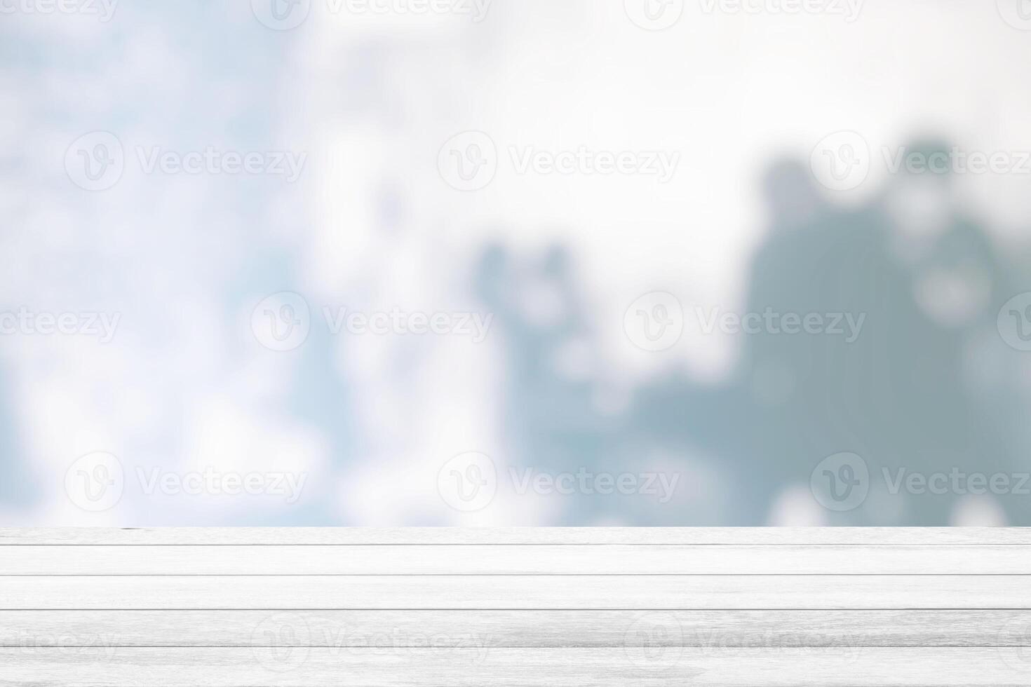 White Wood Table with Blurred White People in Restaurant Room Background, Suitable for Product Display and Business Concept. photo