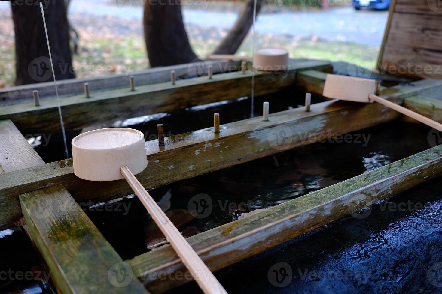 Japanese Holy Water Dipper in front of Hokkaido shrine Mikado where is a tourist attraction in Sapporo, Japan. photo
