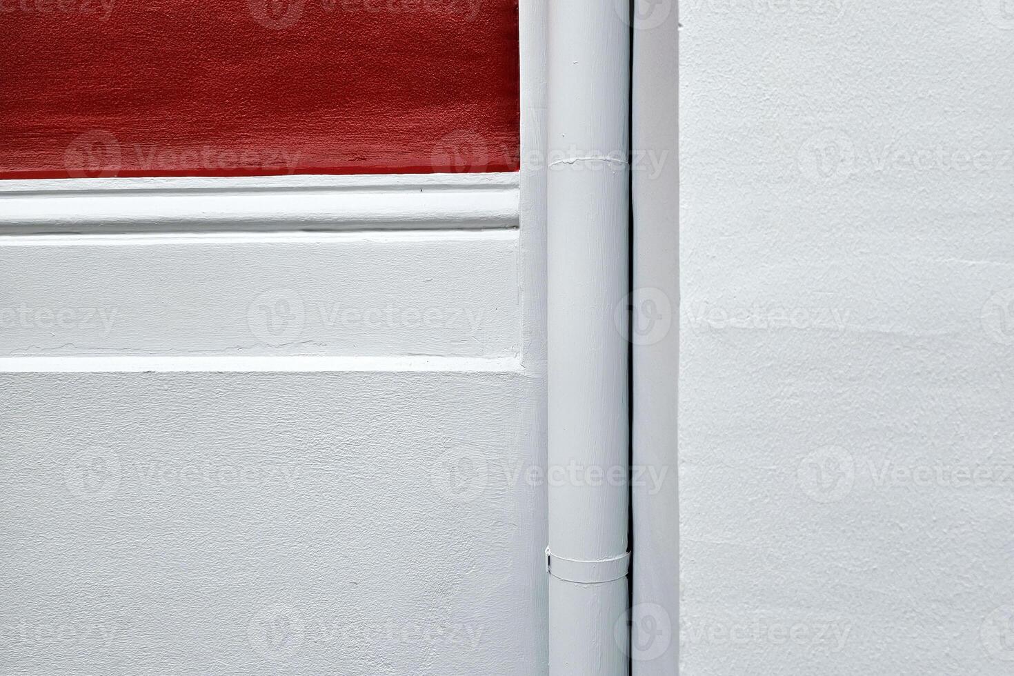 Minimal White and Red Painting Concrete with Drain Pipe Background. photo