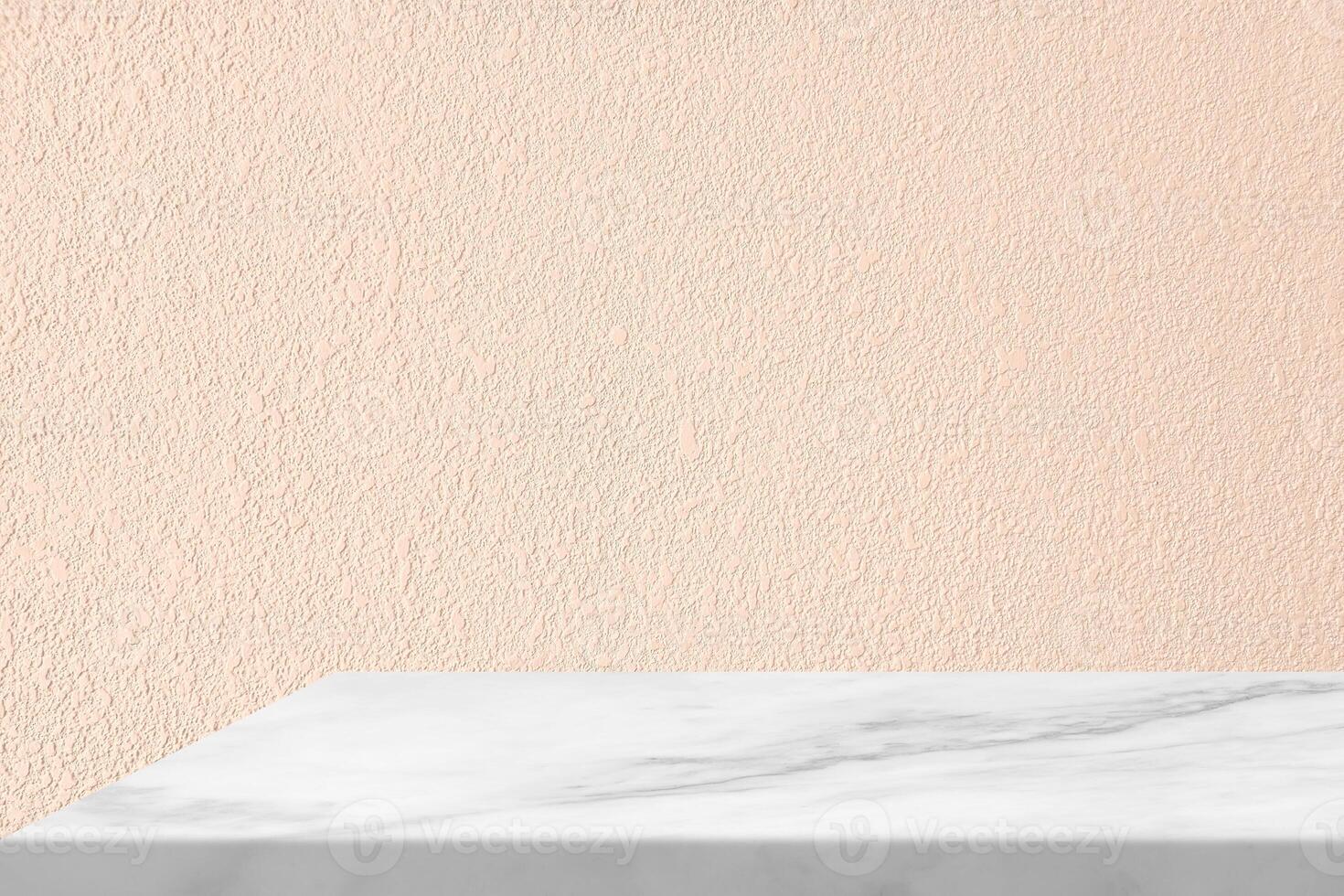 White Marble Table Corner with Light Beam through the Window from the left on Stucco Wall Texture Background in Peach Fuzz Color, Suitable for Product Presentation Backdrop, Display, and Mock up. photo