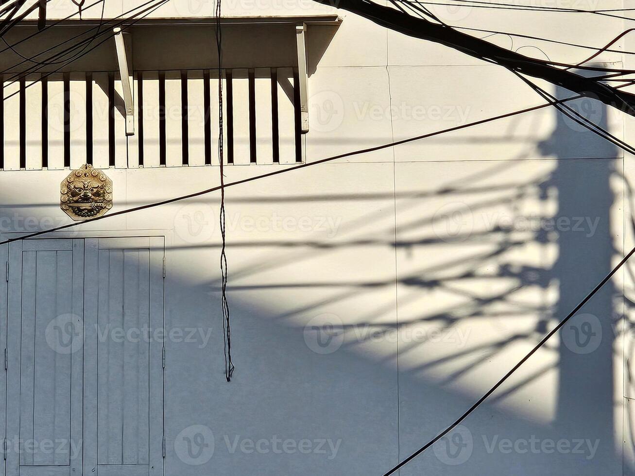 Messy and Electric Pole Shadow on Wall. photo