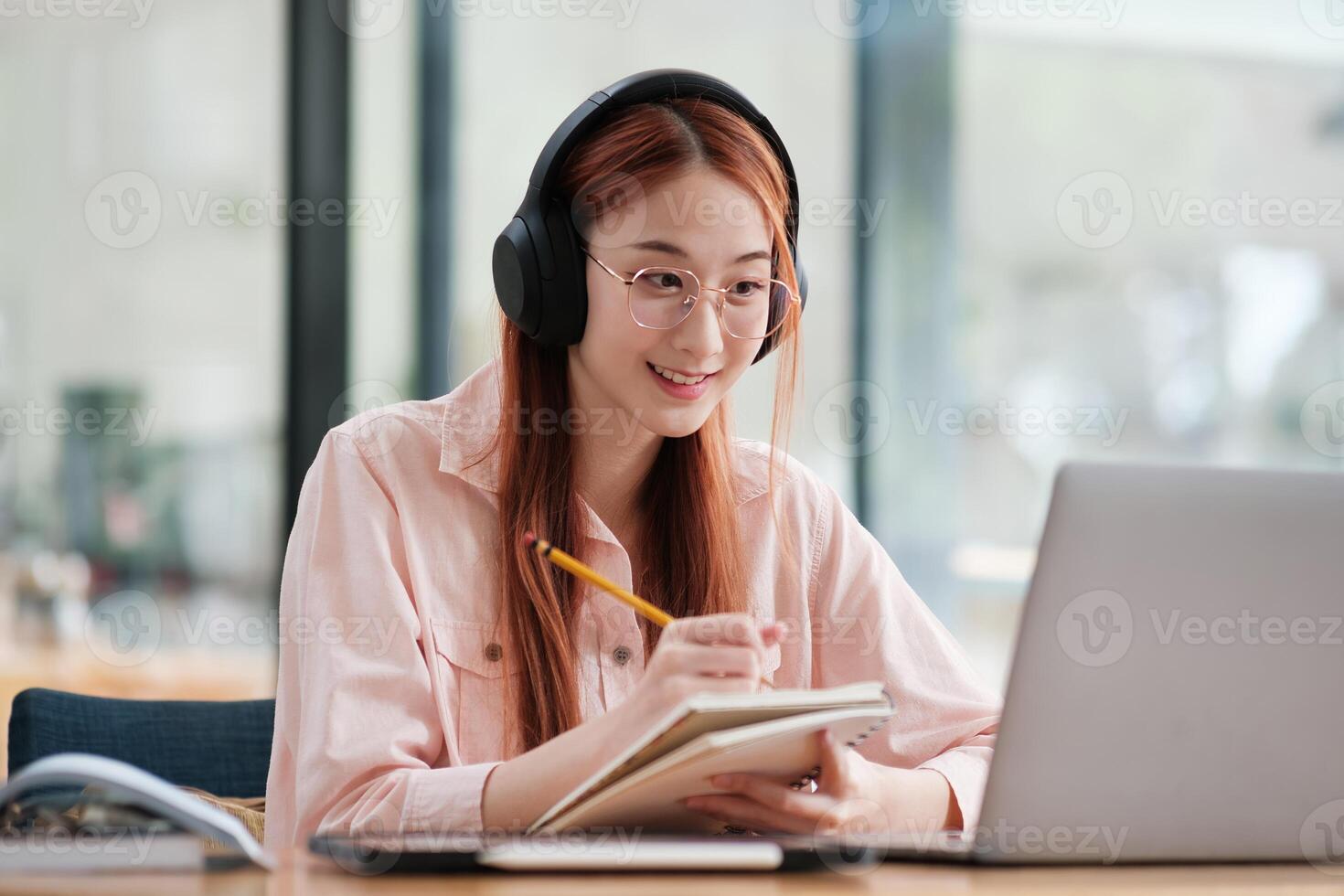 Young collage student using computer and mobile device studying online. photo