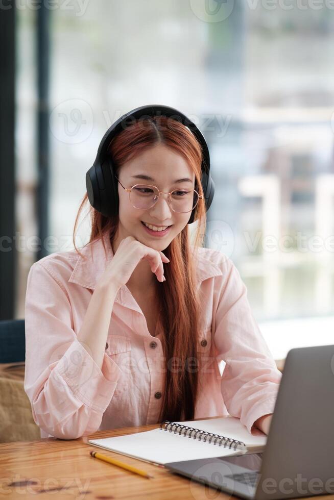 Young collage student using computer and mobile device studying online. photo