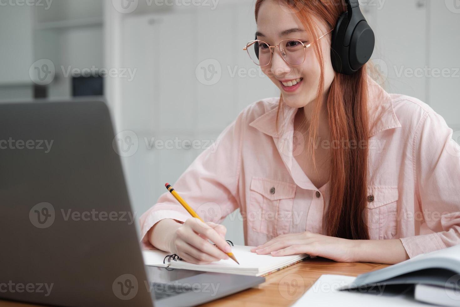 Young collage student using computer and mobile device studying online. photo
