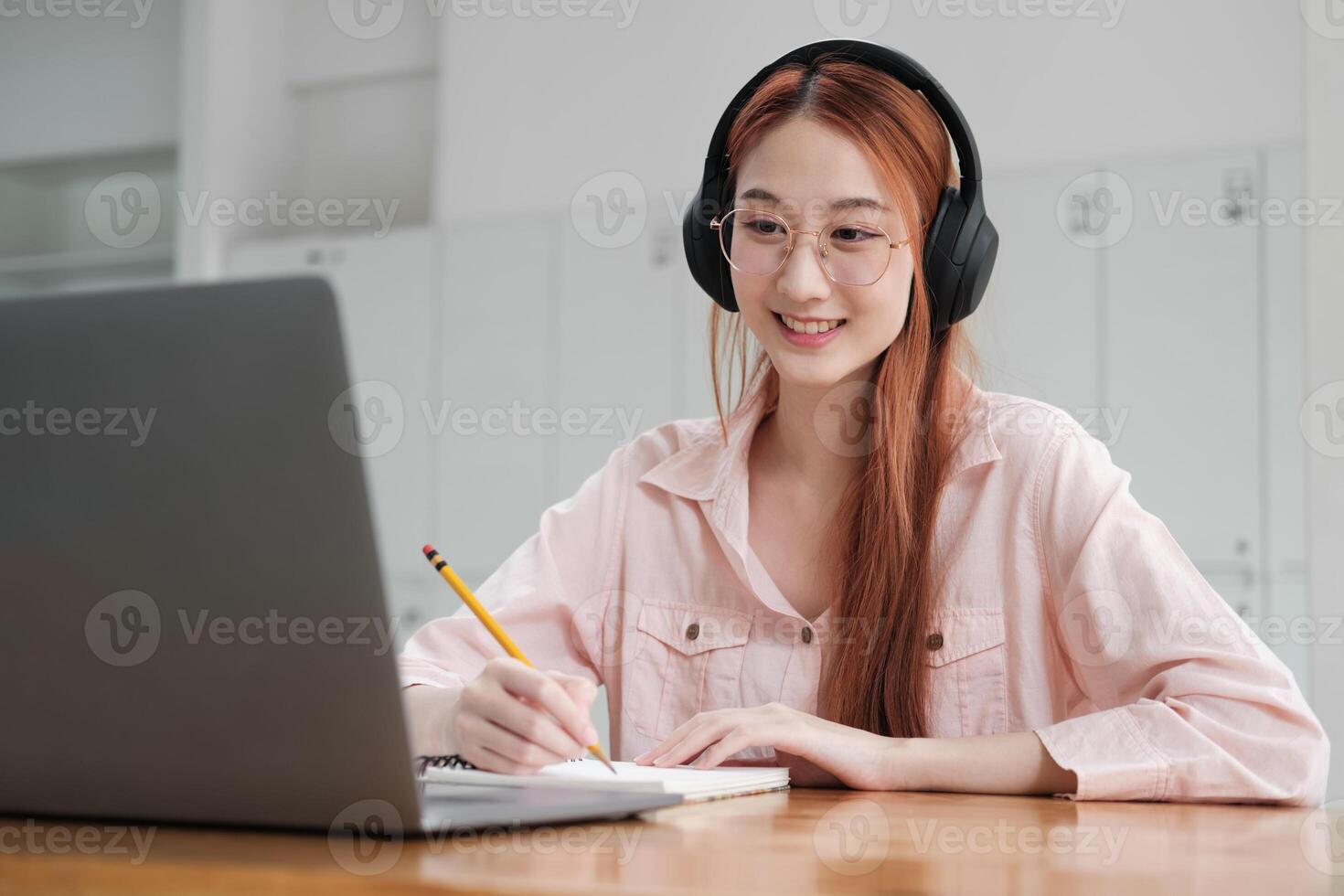 Young collage student using computer and mobile device studying online. photo