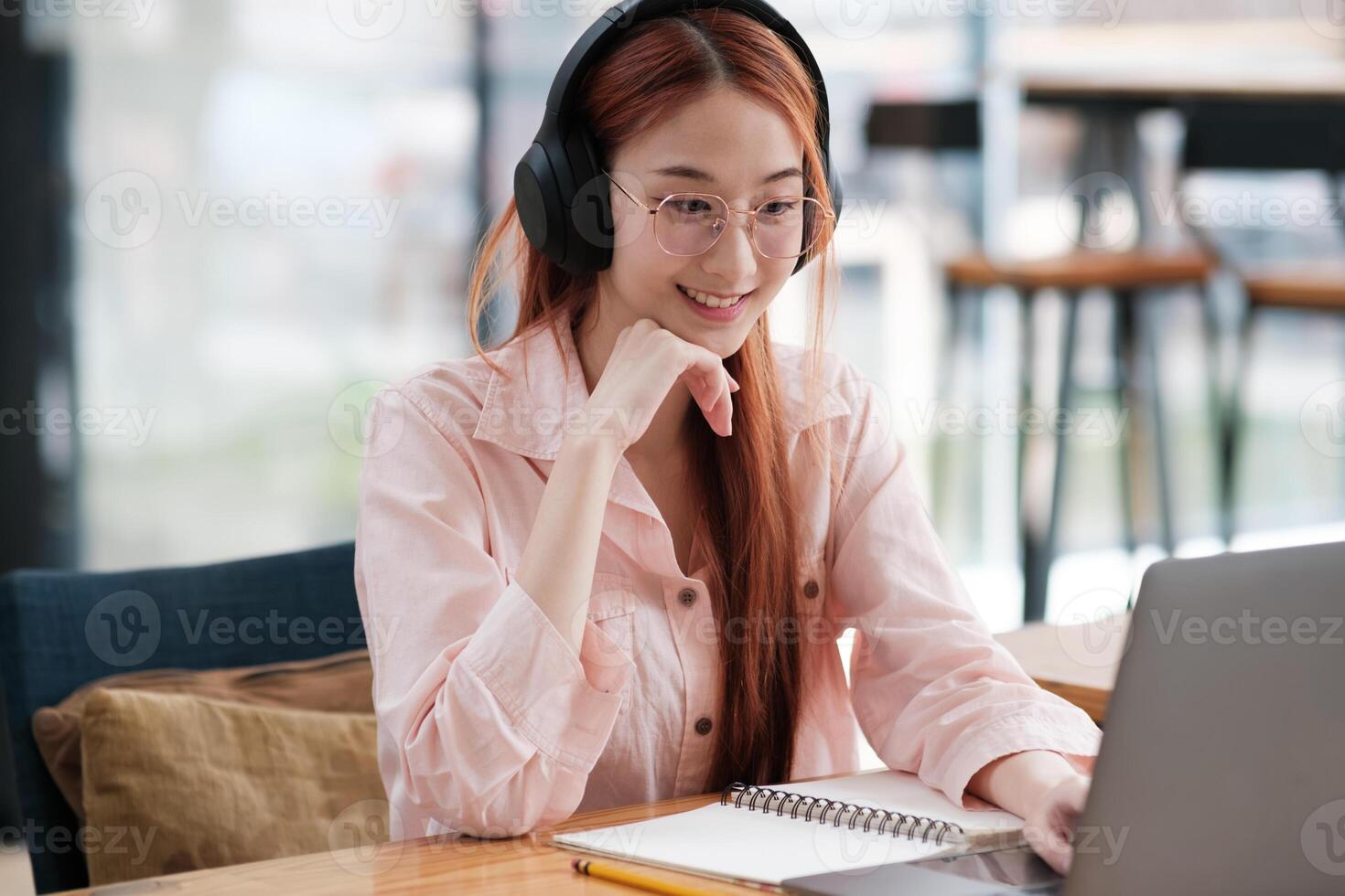 Young collage student using computer and mobile device studying online. photo