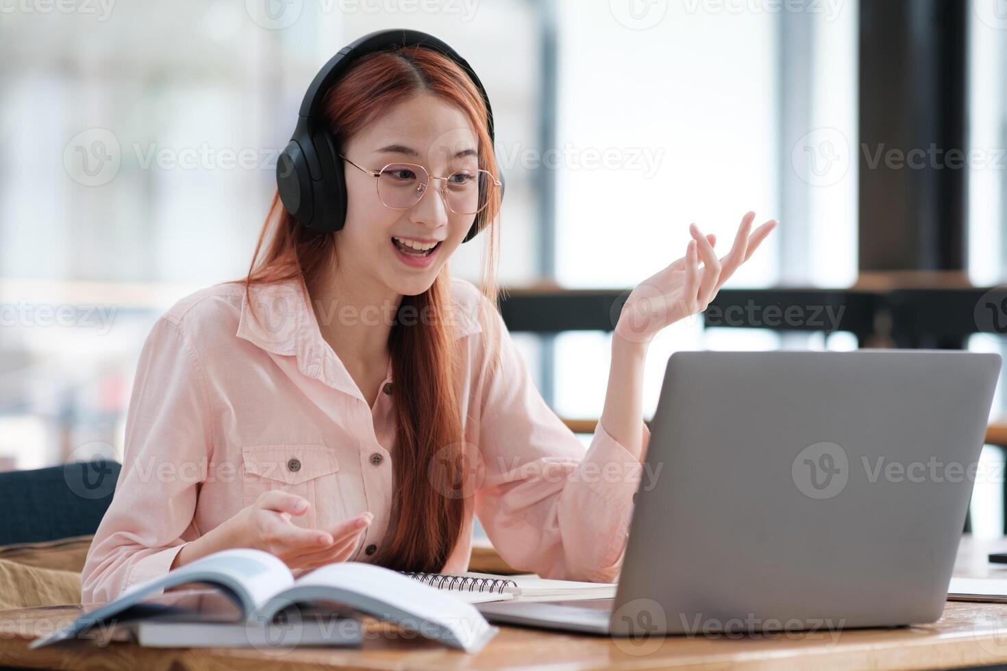 Young collage student using computer and mobile device studying online. photo