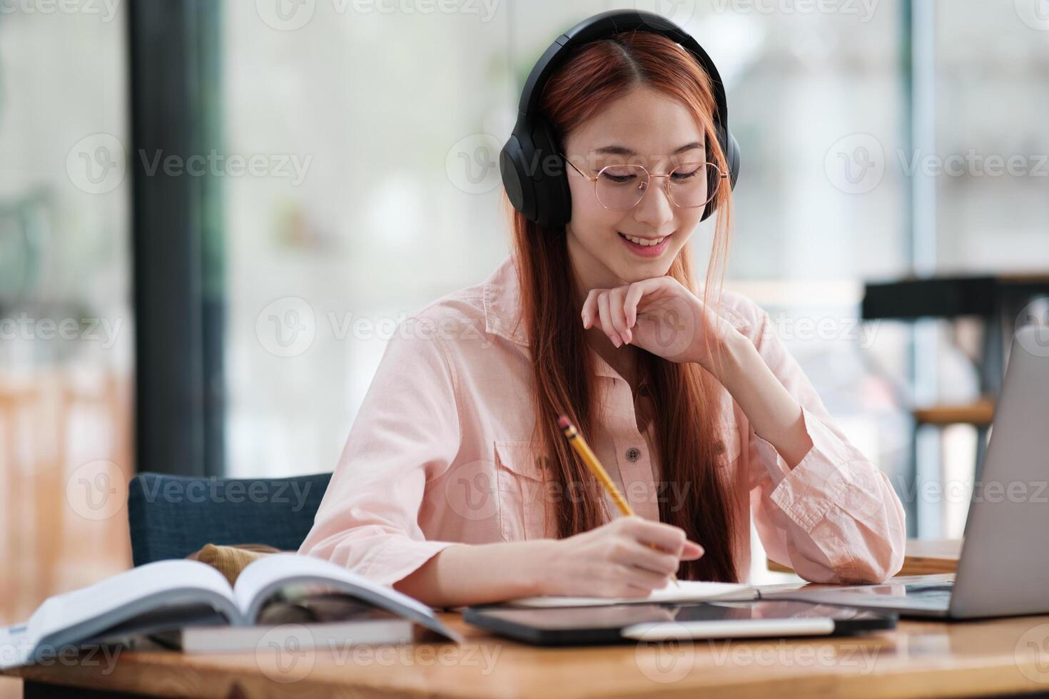 Young collage student using computer and mobile device studying online. photo
