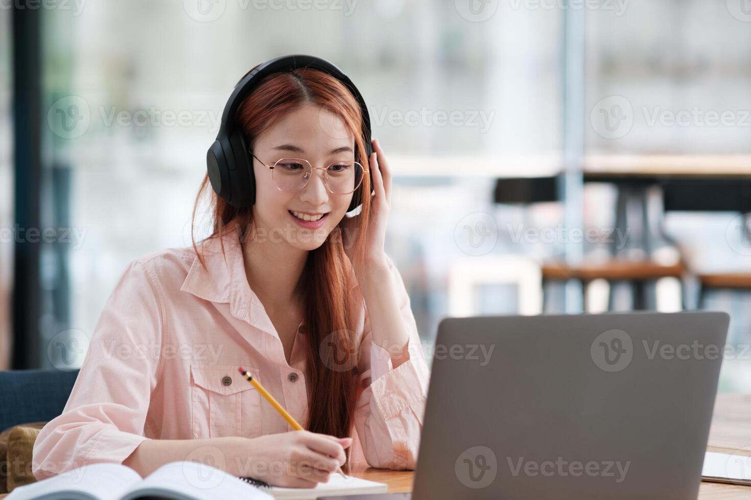Young collage student using computer and mobile device studying online. photo