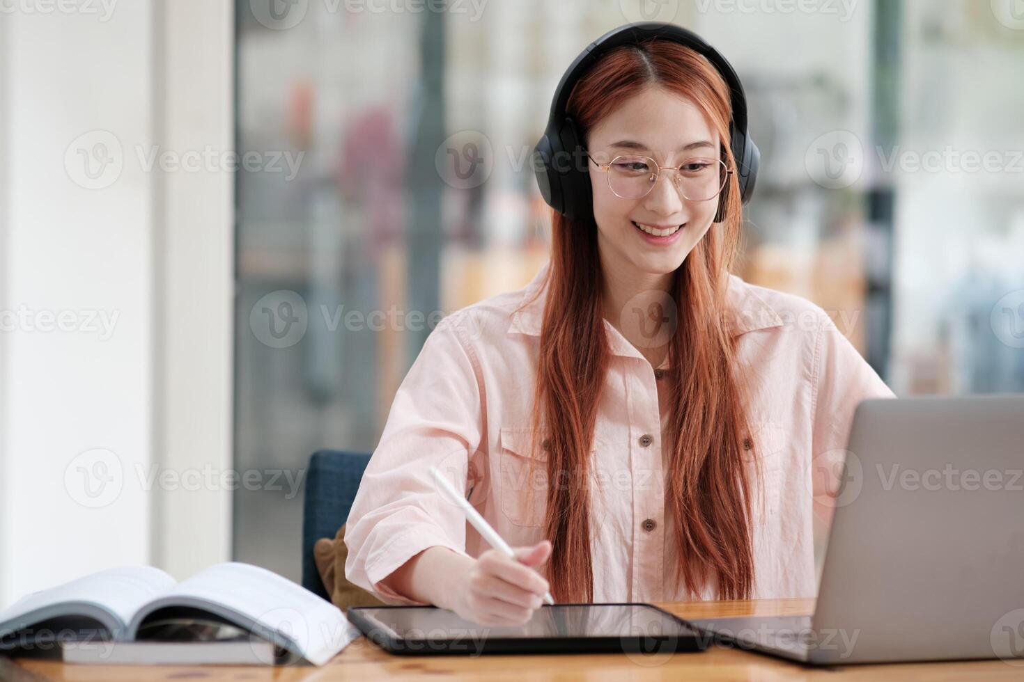 Young collage student using computer and mobile device studying online. photo