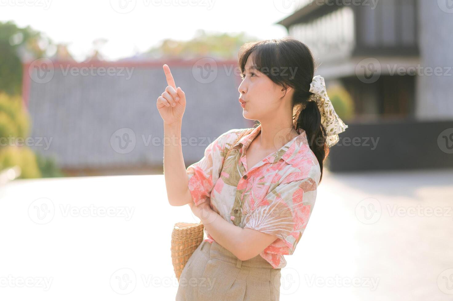 Portrait beautiful young asian woman on summer holiday vacation trip in Thailand. Young hipster female tourist sightseeing summer urban Bangkok destination. Asia summer tourism concept. photo