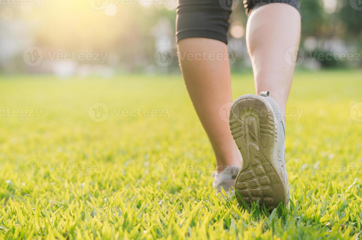 jogger woman. close up person training sport runner young female shoe on grasses in public park. fitness leg and foot exercise athlete. marathon in nature. active healthy lifestyle workout concept. photo