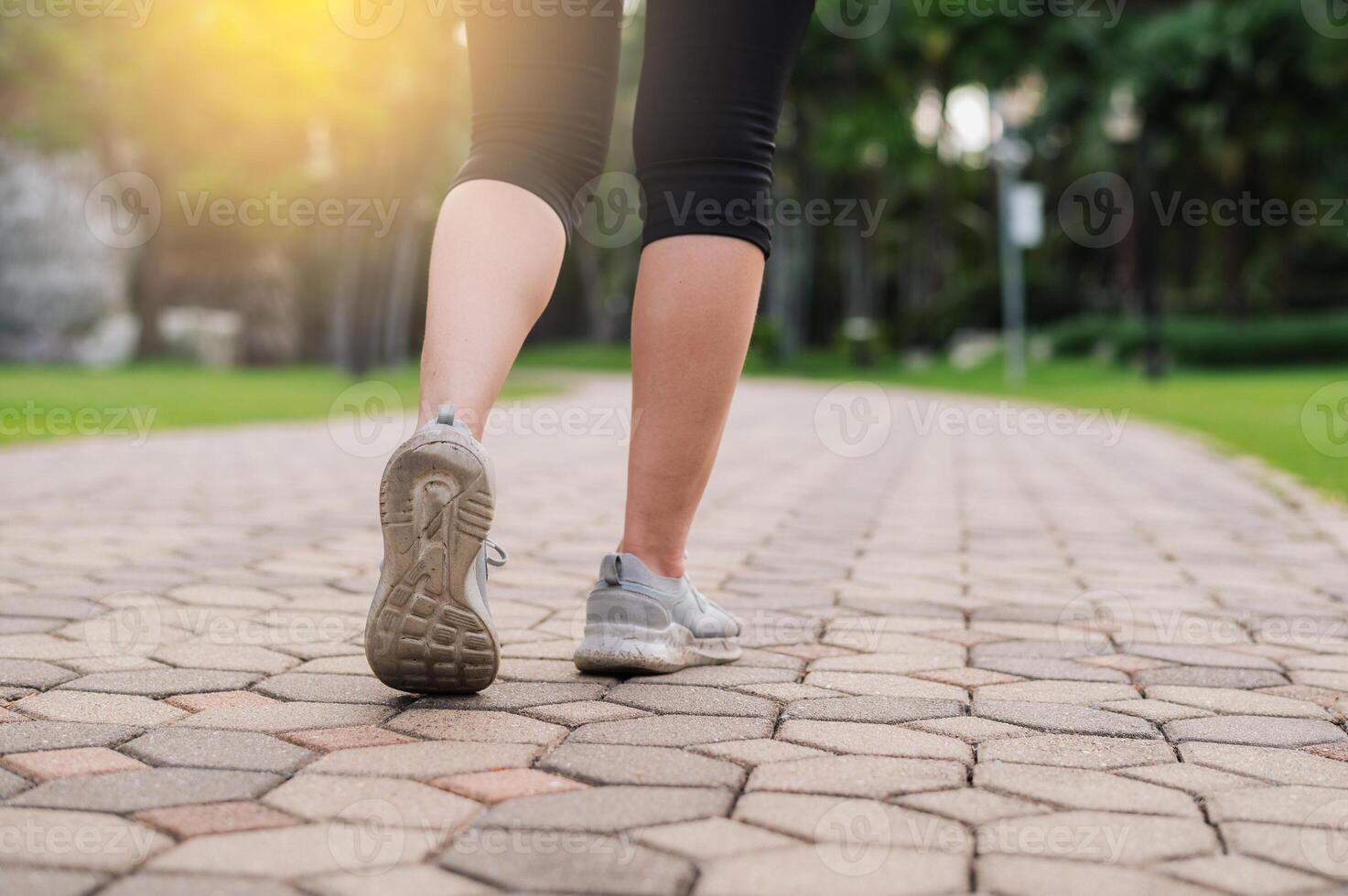 jogger woman. close up person training sport runner young female shoe on walk path in public park. fitness leg and foot exercise athlete. marathon in nature. active healthy lifestyle workout concept. photo